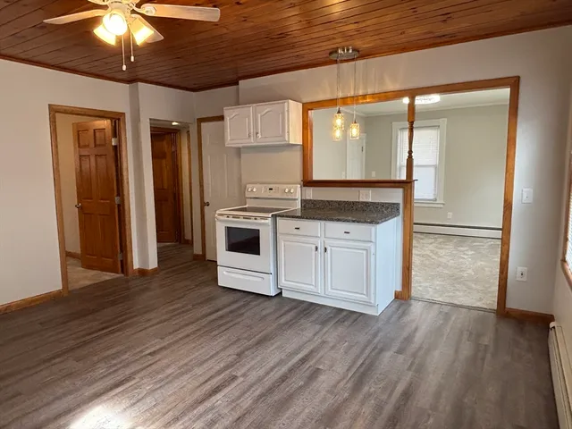 a kitchen with stainless steel appliances a white refrigerator a sink and a stove