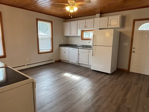 a kitchen with a refrigerator and a stove top oven