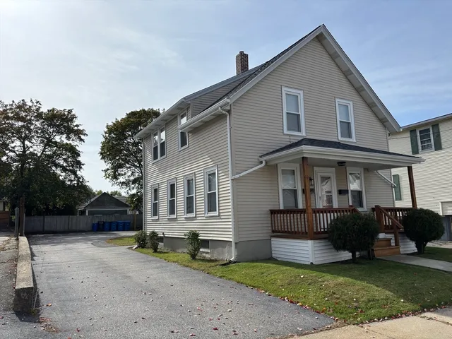 a view of a house with a yard and sitting area