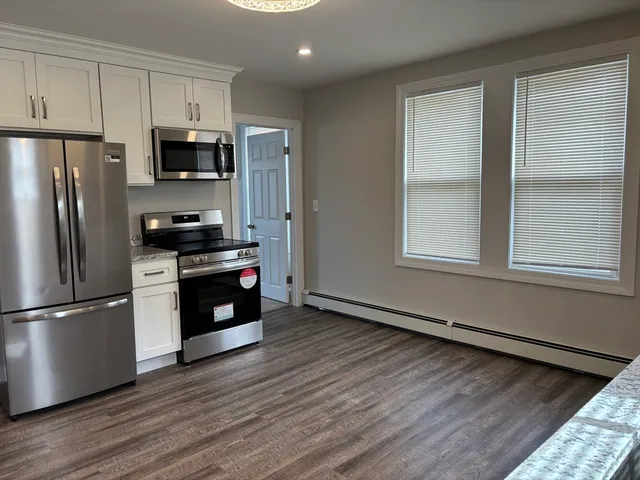 a kitchen with stainless steel appliances a refrigerator stove and microwave