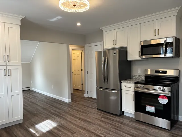 a kitchen with stainless steel appliances a refrigerator stove and microwave