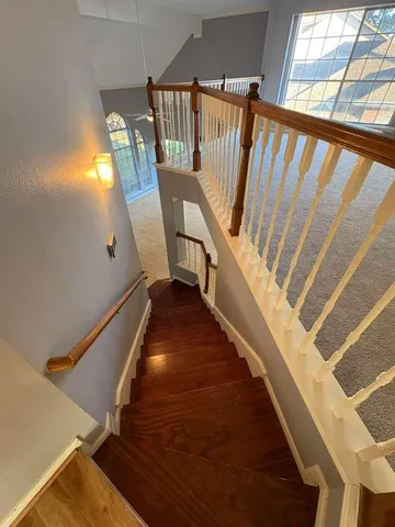 a view of entryway and hall with wooden floor