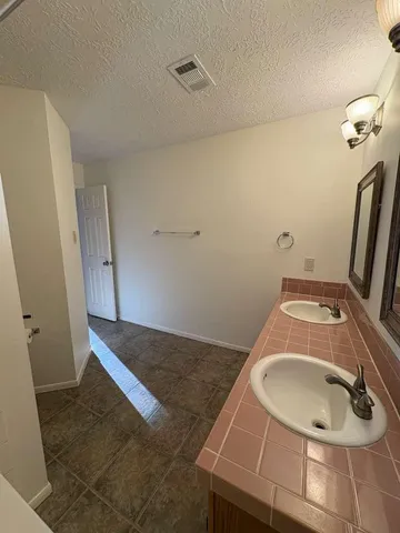 a bathroom with a sink and mirror