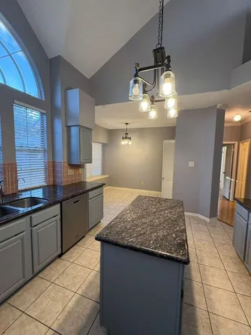 a kitchen with a sink a counter top space and appliances