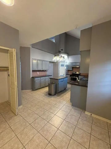 a kitchen with stainless steel appliances granite countertop a refrigerator and a cabinets
