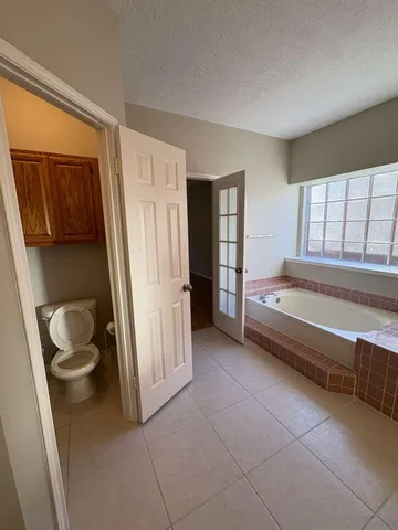 a bathroom with a bathtub and toilet