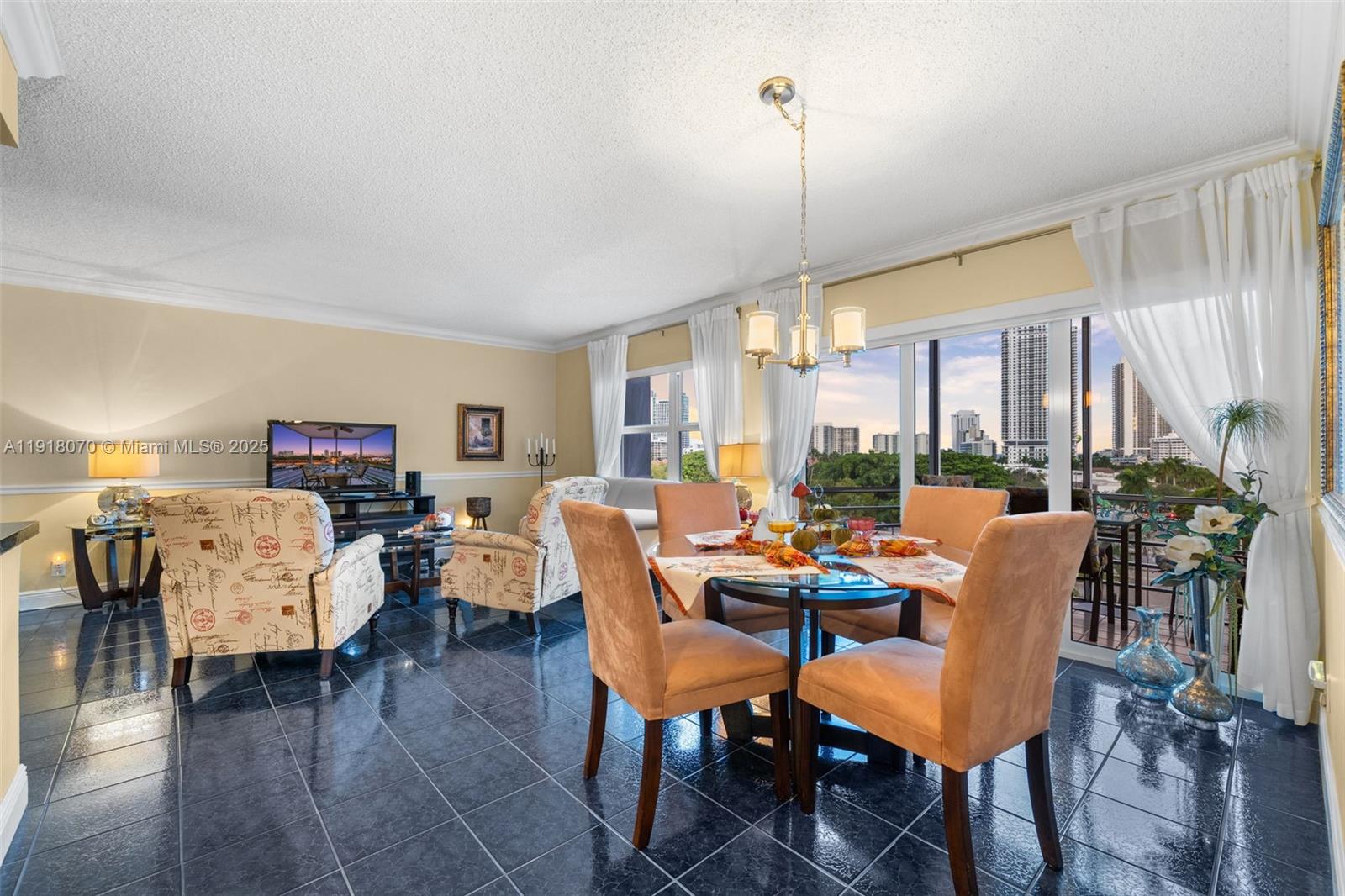 200 Diplomat Parkway, Unit 732 Hallandale Beach, FL 33009 - Photo 13 of 35 a dining room with furniture window wooden floor