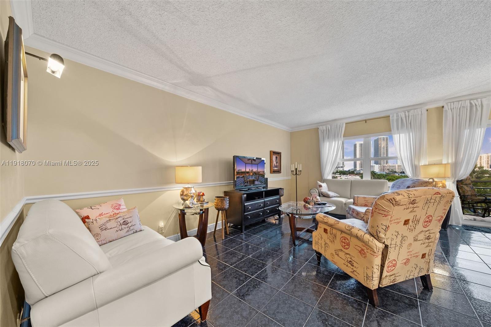 200 Diplomat Parkway, Unit 732 Hallandale Beach, FL 33009 - Photo 14 of 35 a living room with furniture and a flat screen tv