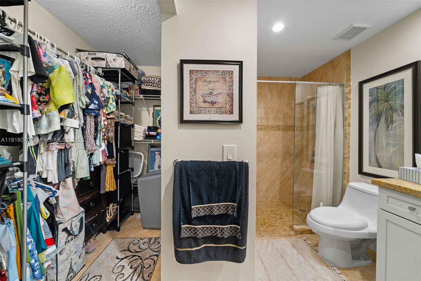 200 Diplomat Parkway, Unit 732 Hallandale Beach, FL 33009 - Photo 15 of 35 a bathroom with a toilet and a shower curtain