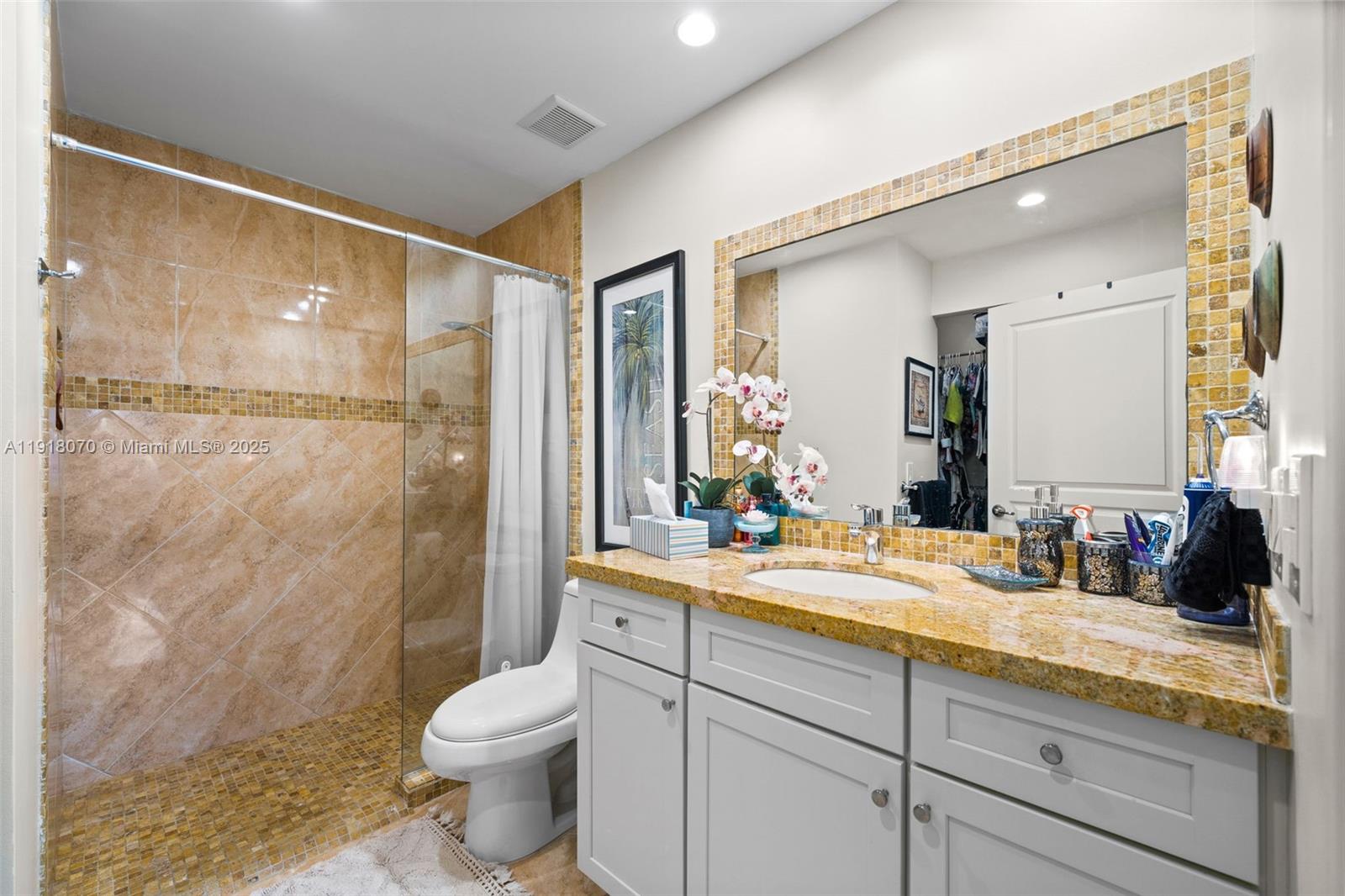 200 Diplomat Parkway, Unit 732 Hallandale Beach, FL 33009 - Photo 17 of 35 a bathroom with a granite countertop sink toilet and shower