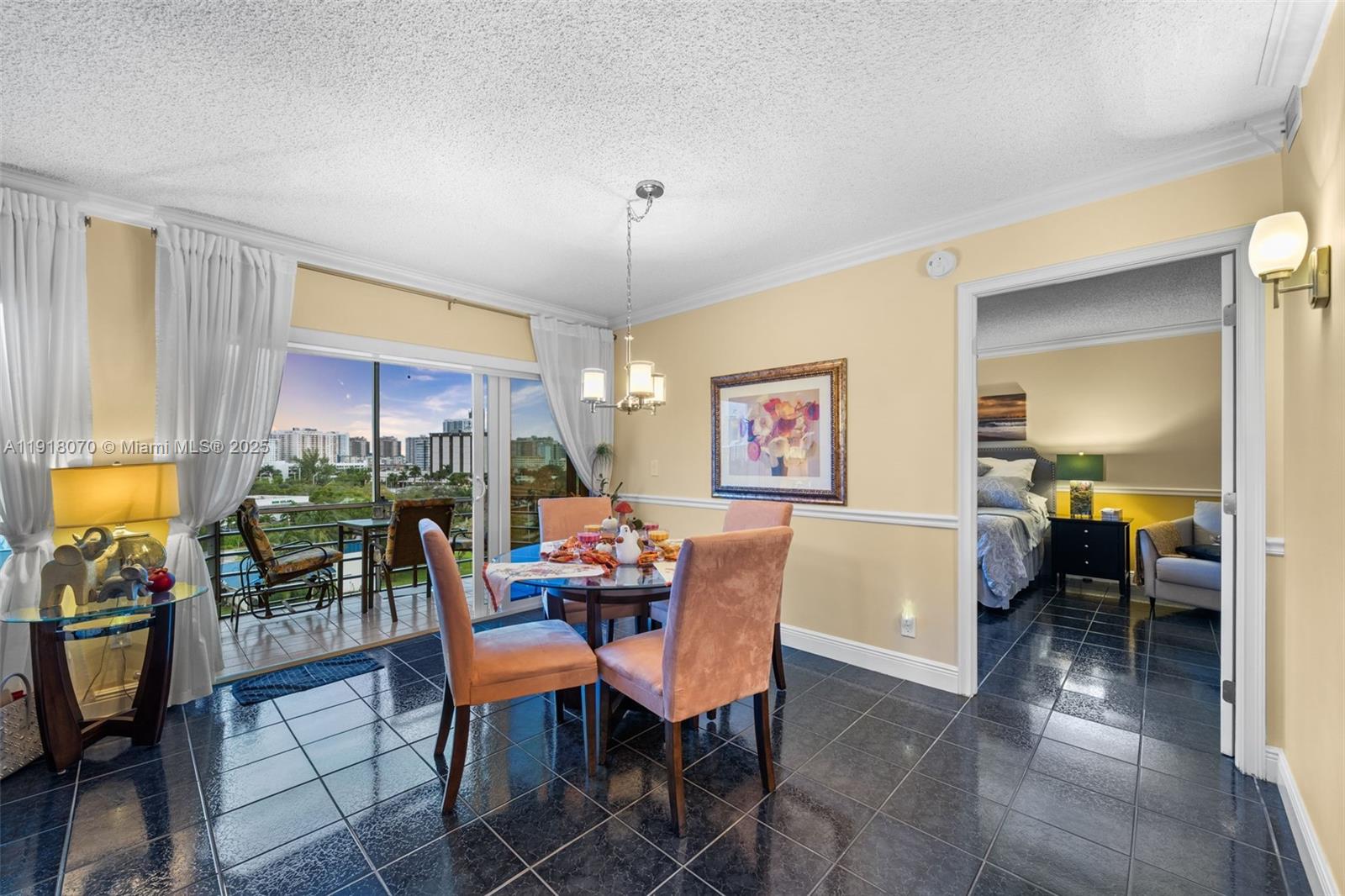 200 Diplomat Parkway, Unit 732 Hallandale Beach, FL 33009 - Photo 3 of 35 a dining room with furniture and a chandelier