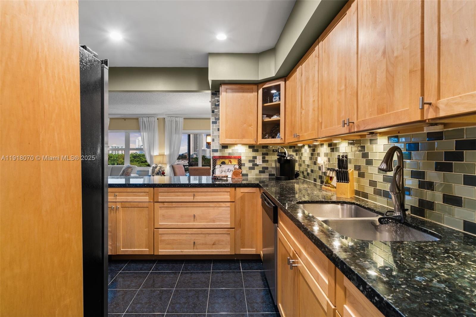 200 Diplomat Parkway, Unit 732 Hallandale Beach, FL 33009 - Photo 7 of 35 a kitchen with stainless steel appliances granite countertop a sink and a cabinets