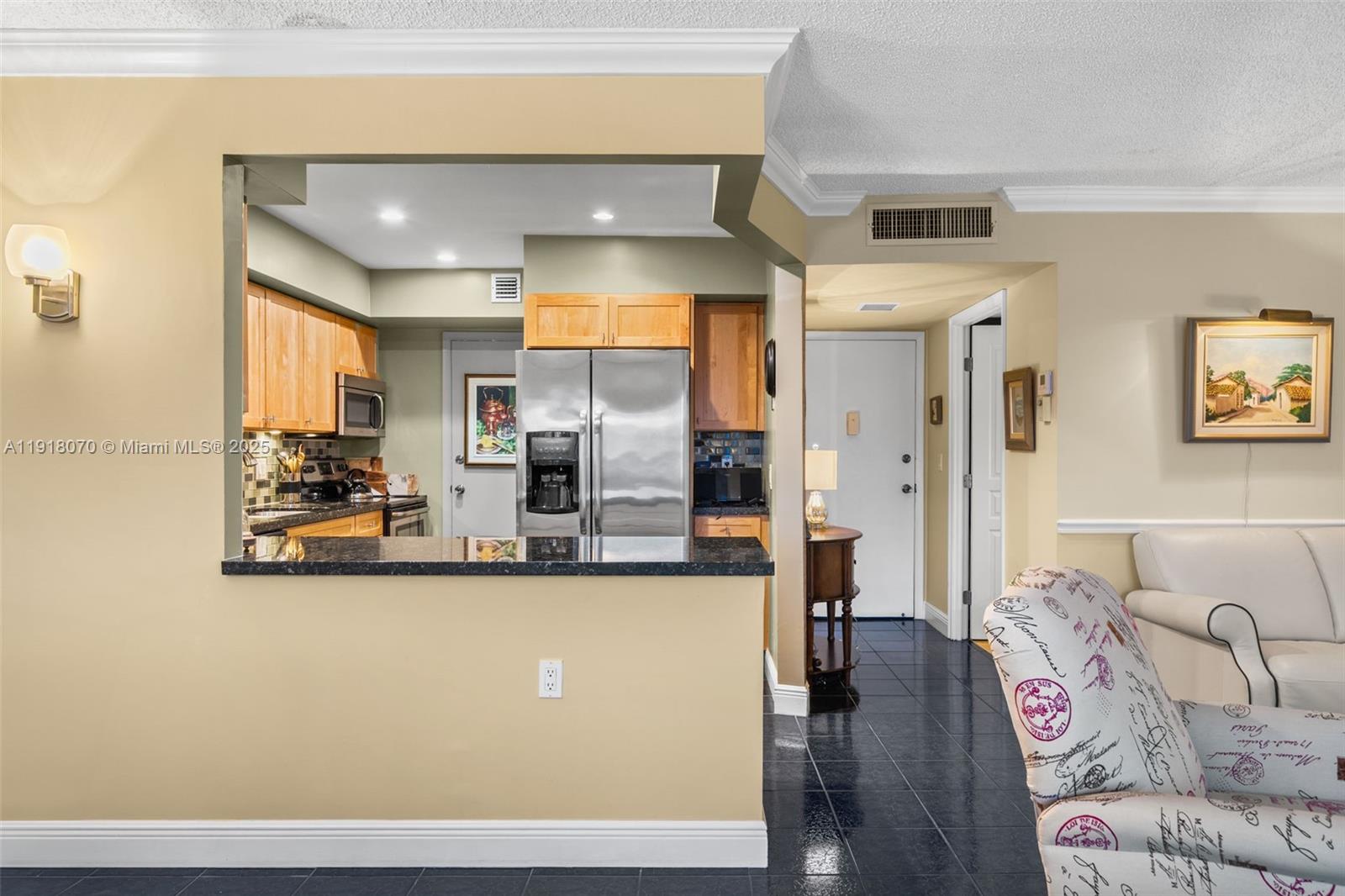 200 Diplomat Parkway, Unit 732 Hallandale Beach, FL 33009 - Photo 9 of 35 a living room with stainless steel appliances kitchen island granite countertop a couch and wooden floor