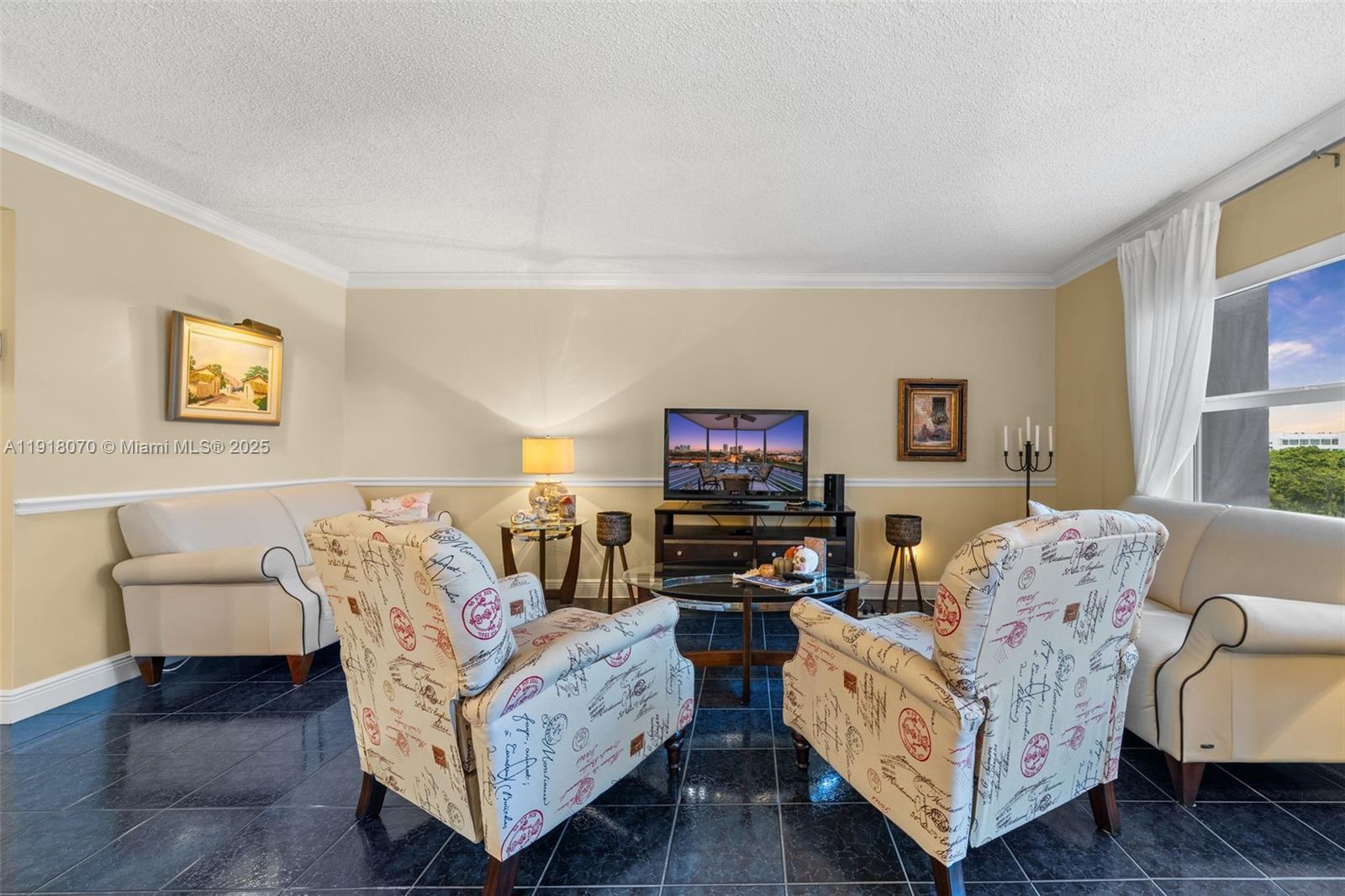 200 Diplomat Parkway, Unit 732 Hallandale Beach, FL 33009 - Photo 10 of 35 a living room with furniture and a flat screen tv