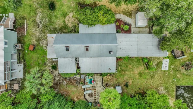 an aerial view of residential houses with outdoor space and trees