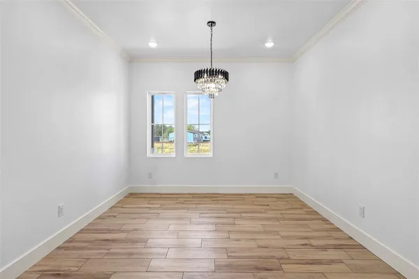 a very nice looking room with wooden floor and windows