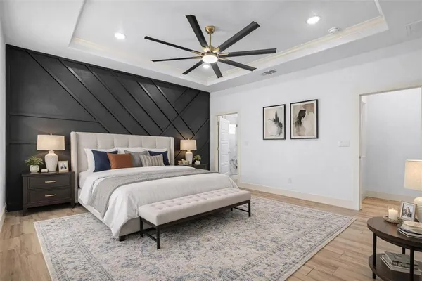 a bedroom with a bed and ceiling fan