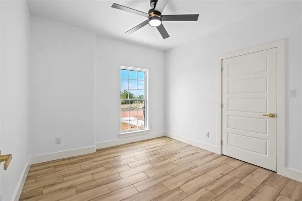 wooden floor in an empty room with a window