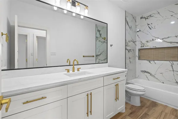 a bathroom with a sink a toilet and a bathtub