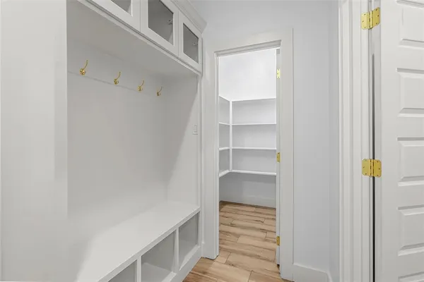a view of walk in closet with empty racks
