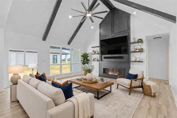 a living room with furniture a fireplace and a flat screen tv