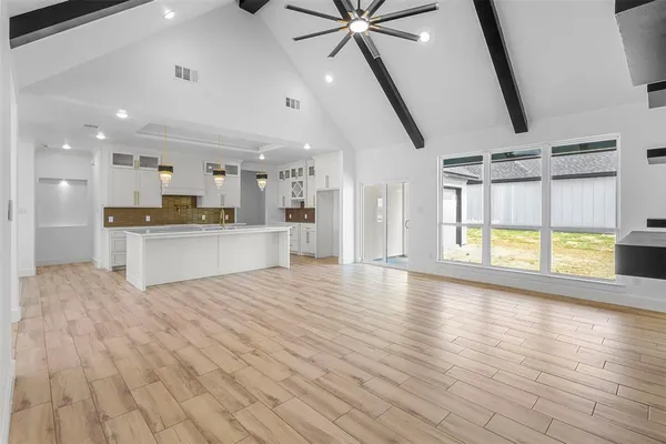 a view of a kitchen with a sink a refrigerator and window