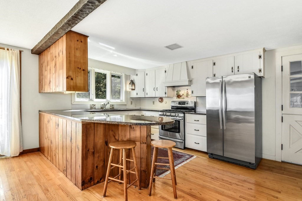 28 Olde Farms Road Boxford, MA 01921 - Photo 11 of 42 a kitchen with stainless steel appliances granite countertop a refrigerator and a stove top oven