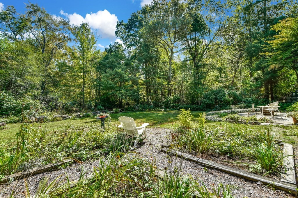 28 Olde Farms Road Boxford, MA 01921 - Photo 35 of 42 a view of a garden with a bench