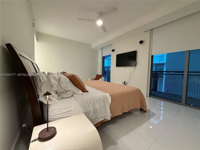 a bedroom with a bed and a television