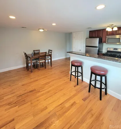 a view of a room with furniture and a wooden floor