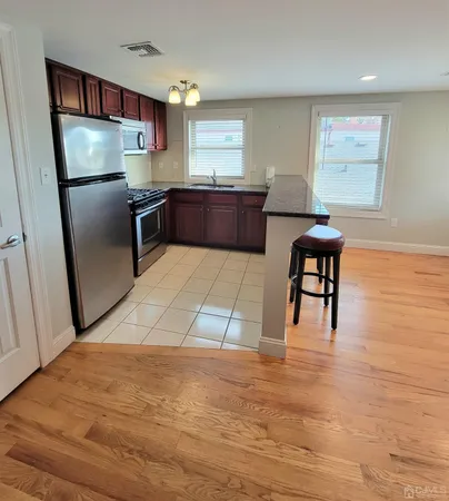 a kitchen with stainless steel appliances a refrigerator sink and cabinets