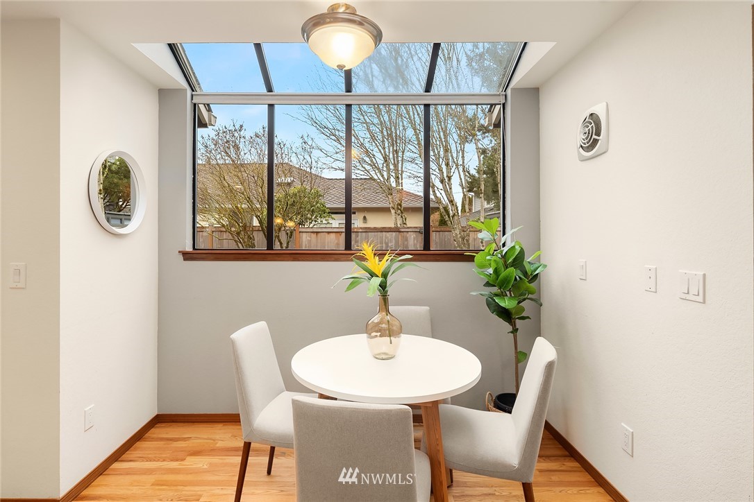 2411 241st Street Southeast Bothell, WA 98021 - Photo 13 of 38 a dining room with furniture potted plants and wooden floor