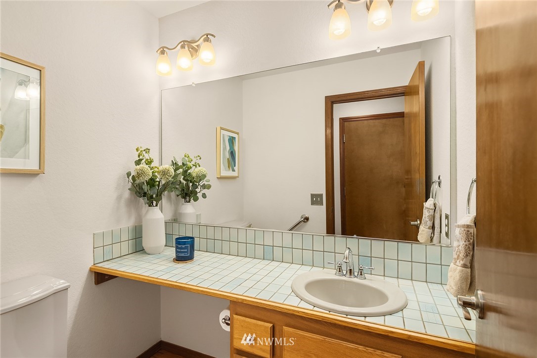 2411 241st Street Southeast Bothell, WA 98021 - Photo 19 of 38 a bathroom with a sink and a mirror