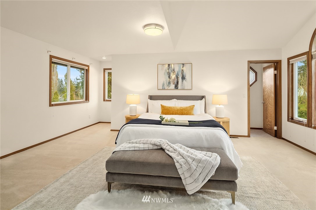 2411 241st Street Southeast Bothell, WA 98021 - Photo 32 of 38 a bedroom with a bed and a painting on the wall