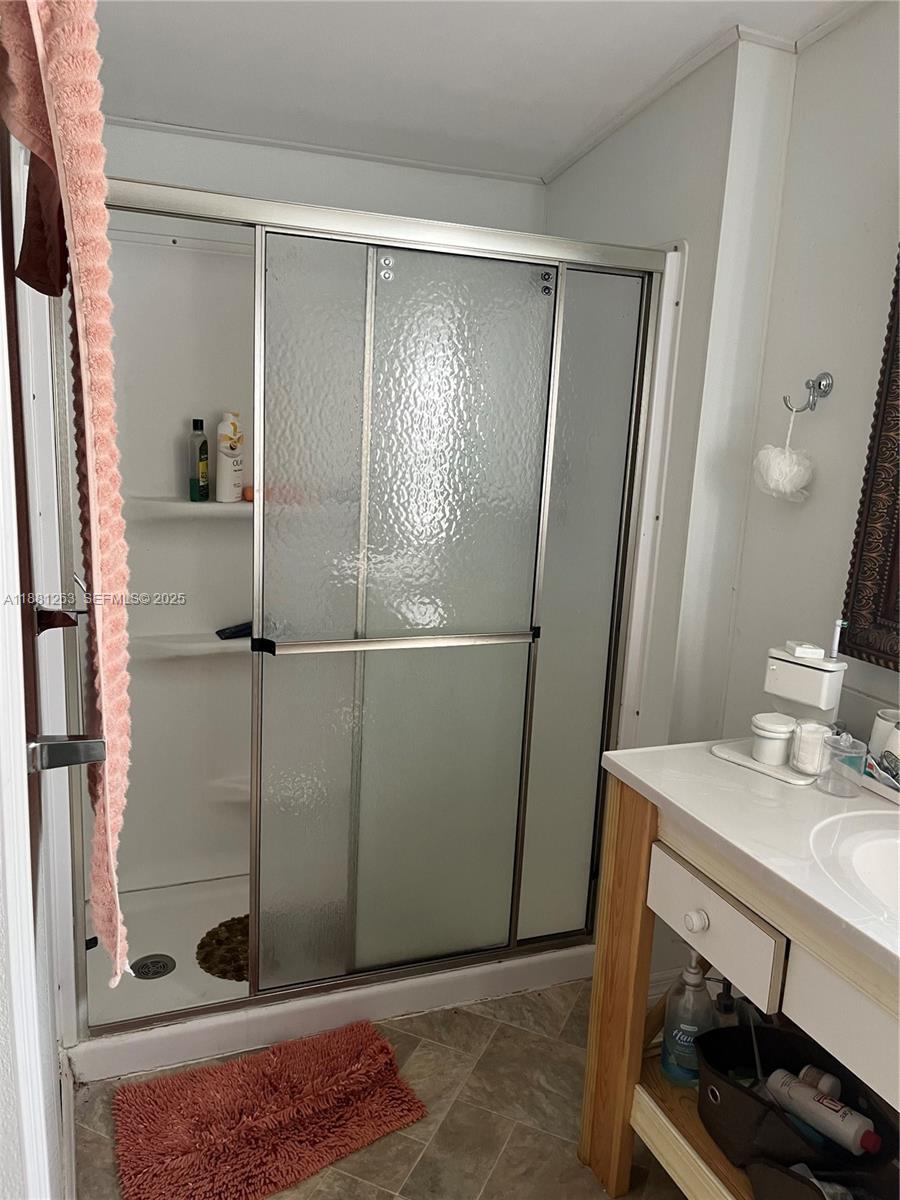 105 Farrer Road Frostproof, FL 33843 - Photo 14 of 48 a bathroom with a sink and a mirror