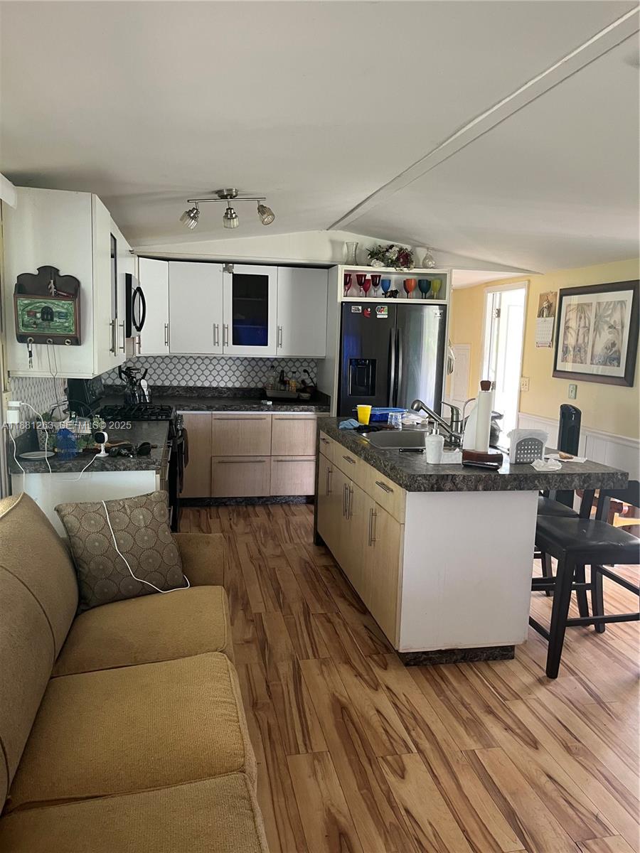 105 Farrer Road Frostproof, FL 33843 - Photo 23 of 48 a living room with furniture and kitchen view