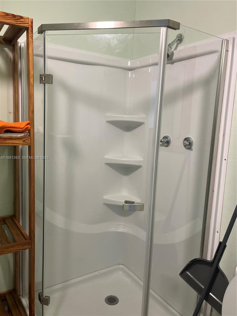 105 Farrer Road Frostproof, FL 33843 - Photo 45 of 48 a bathroom with a glass shower door