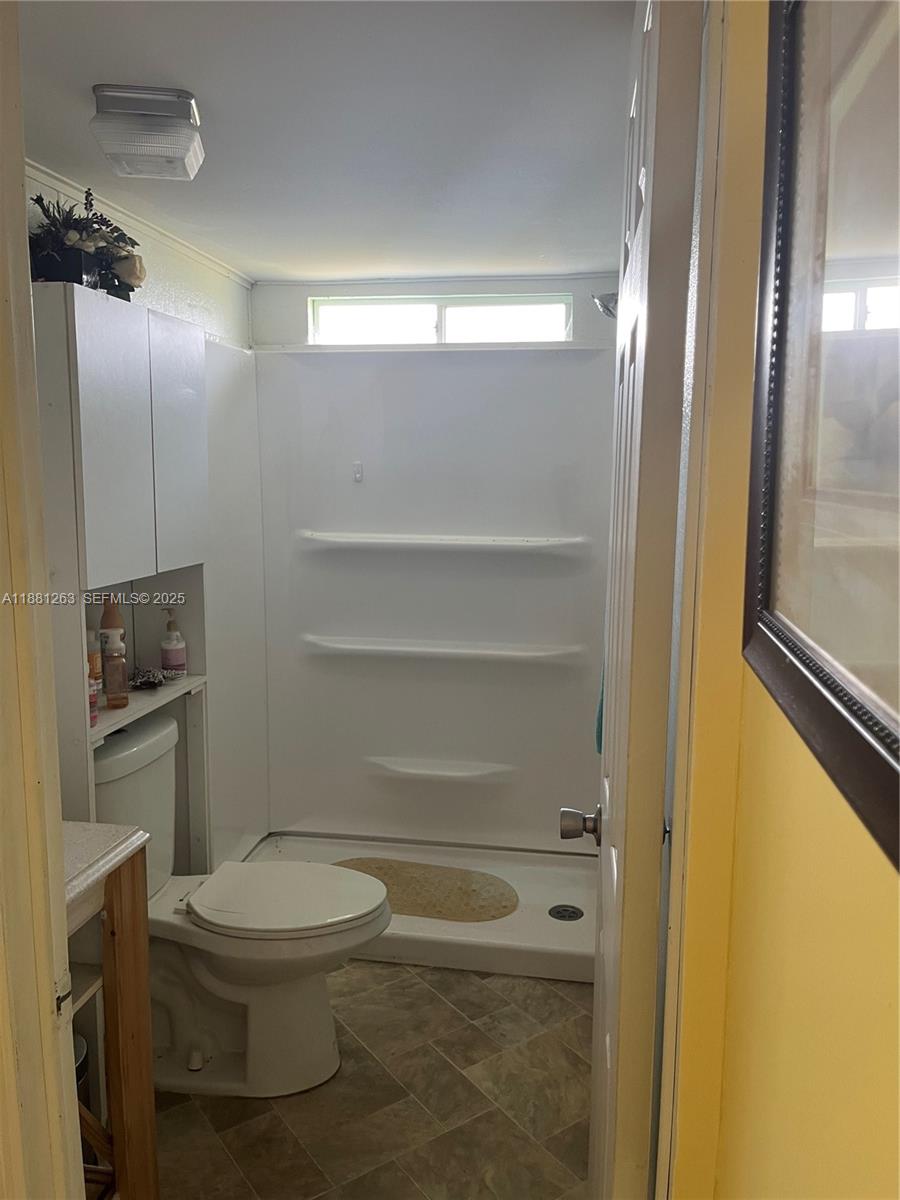 105 Farrer Road Frostproof, FL 33843 - Photo 8 of 48 a bathroom with a toilet and a shower