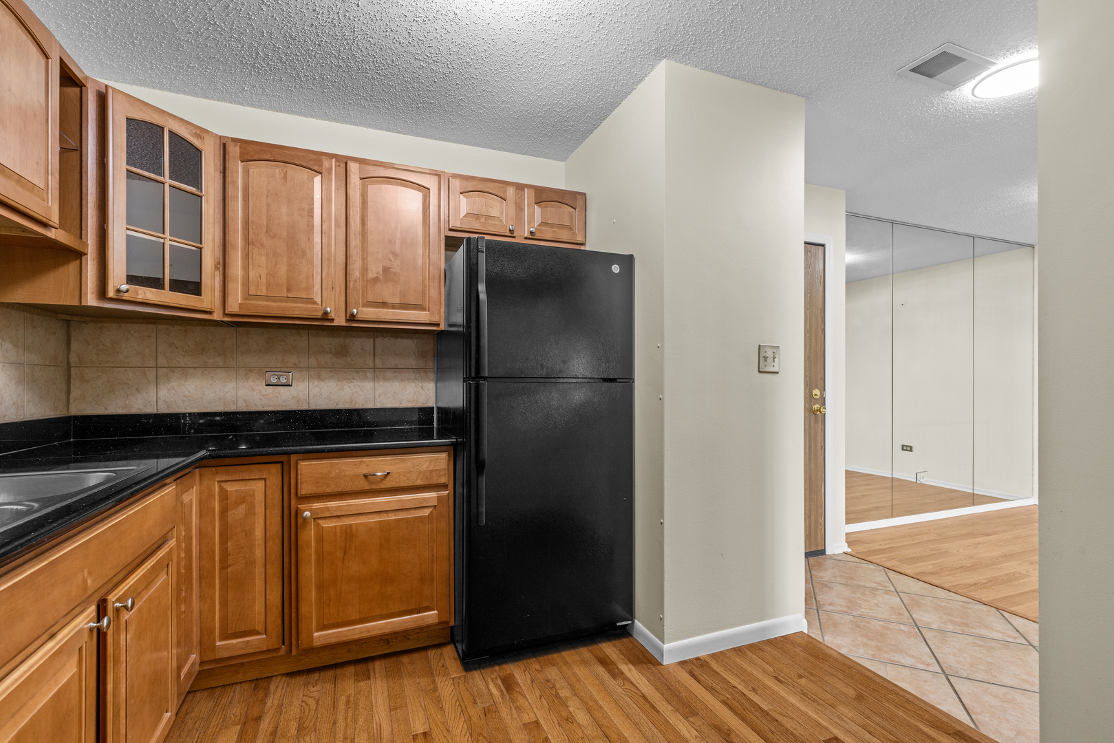 720 Weidner Road, Unit 302 Buffalo Grove, IL 60089 - Photo 14 of 27 a kitchen with stainless steel appliances granite countertop a refrigerator and a sink