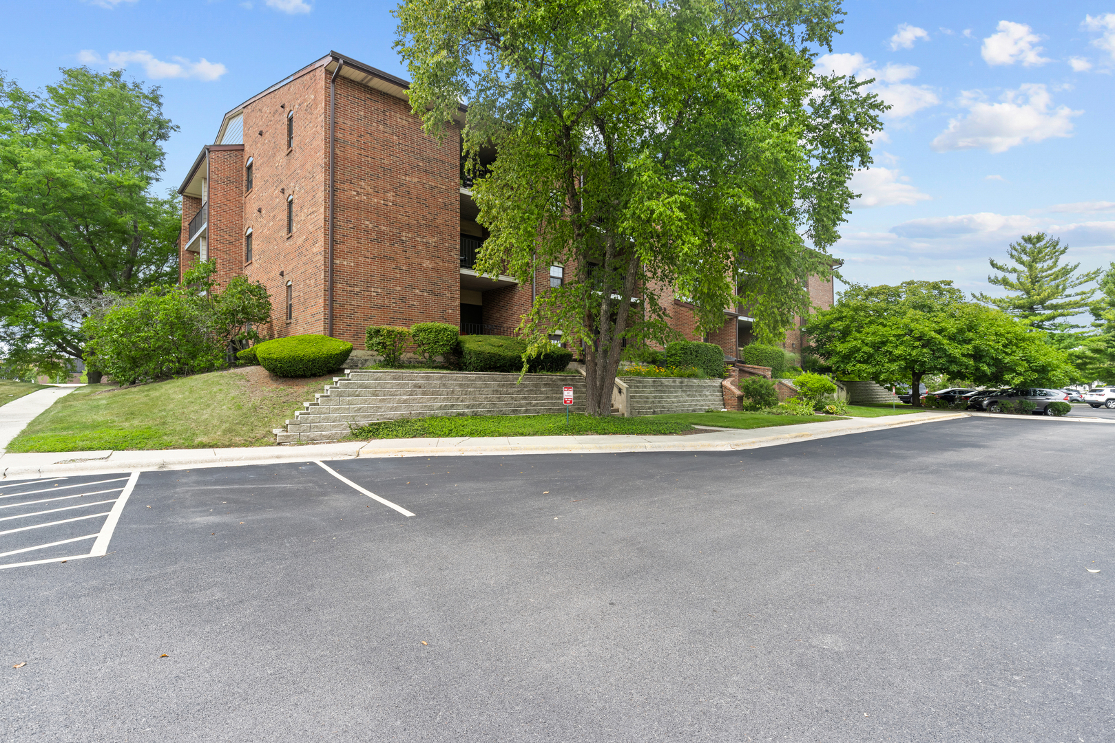 720 Weidner Road, Unit 302 Buffalo Grove, IL 60089 - Photo 2 of 27 a view of a house with a yard and garage