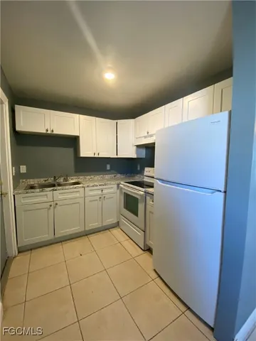 a kitchen with cabinets stainless steel appliances and sink
