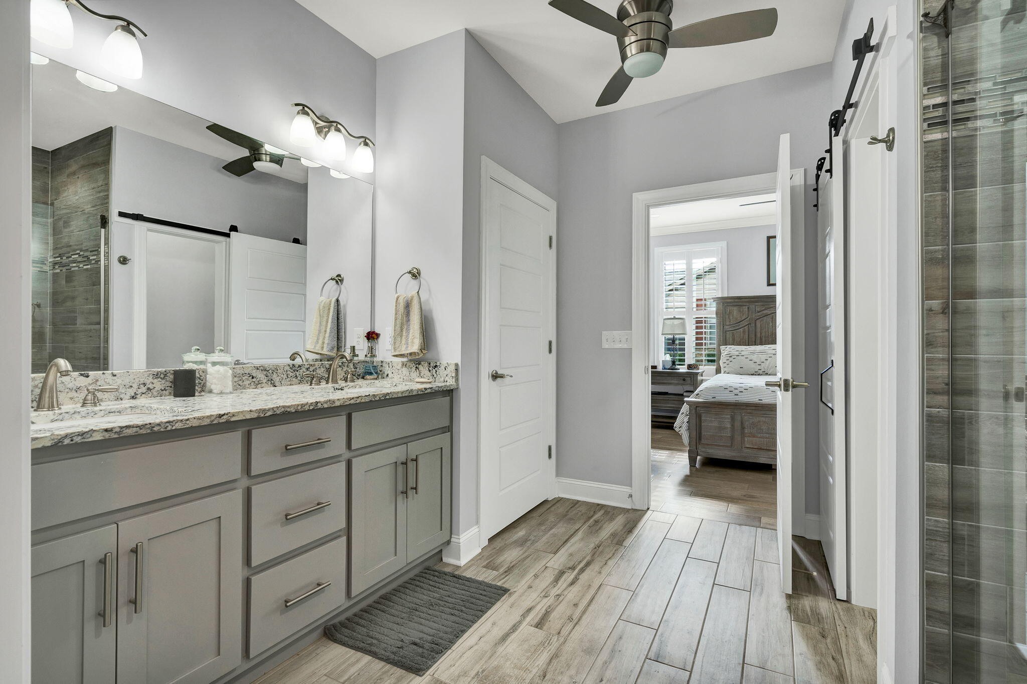 133 Camden Way Dalton, GA 30721 - Photo 19 of 39 a en suite bathroom with a granite countertop sink mirror and a shower