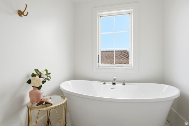 71 Farm Road Midway, UT 84049 - Photo 58 of 92 Freestanding soaking tub with polished chrome fixtures, set beneath a white-framed window