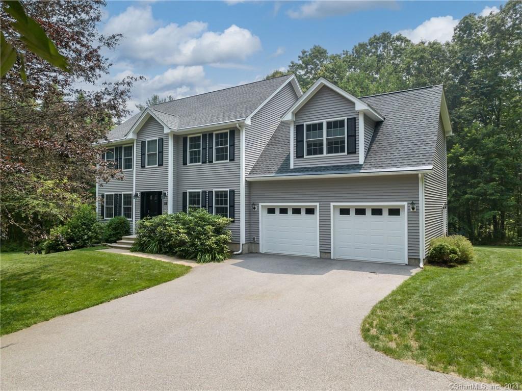 58 Trowbridge Road Coventry, CT 06238 - Photo 1 of 1 a front view of a house with a garden and garage