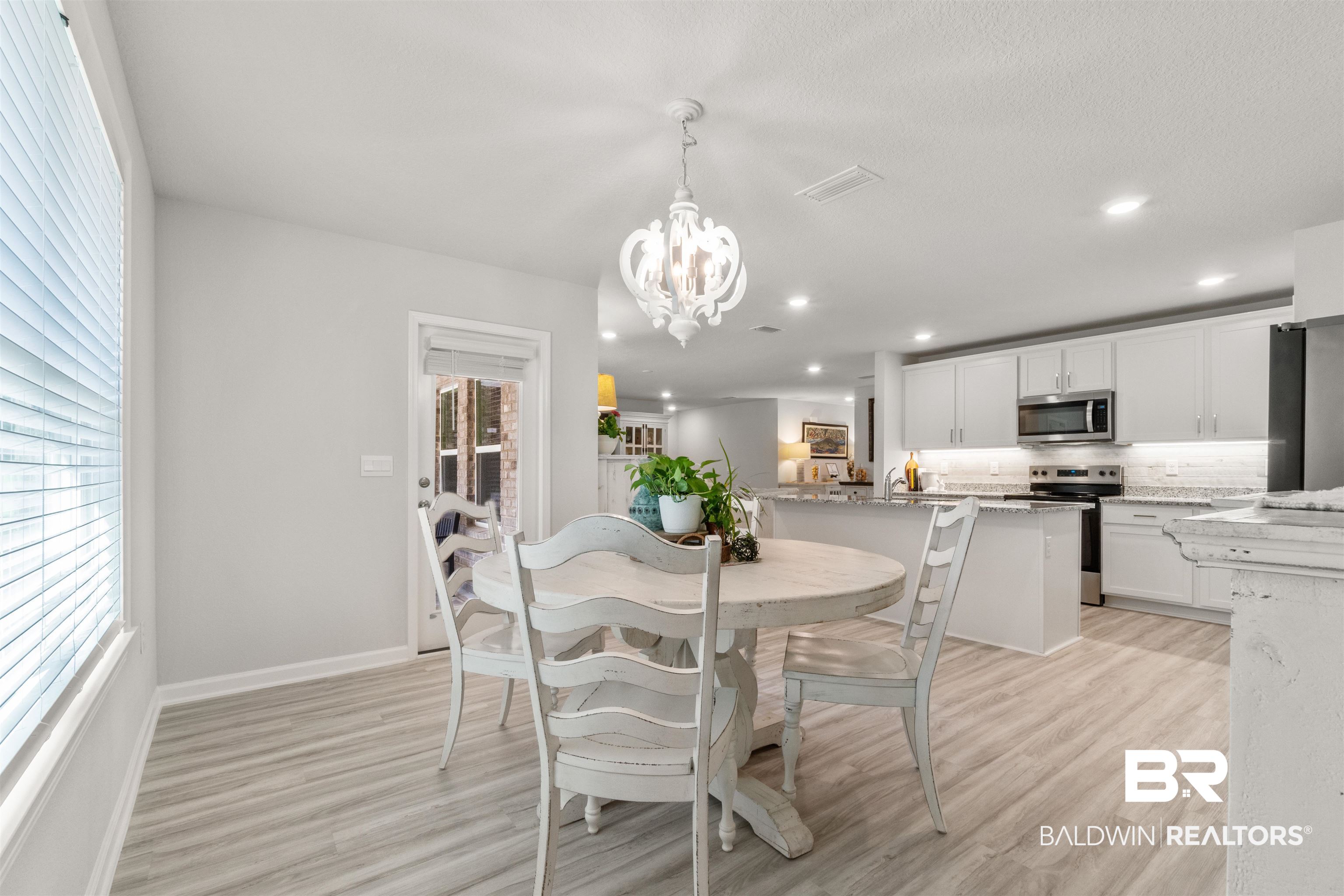 24472 Ringneck Loop Elberta, AL 36530 - Photo 14 of 46 Dining room with an inviting chandelier and light hardwood / wood-style floors