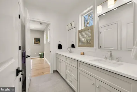 a white bath tub sitting next to a blue sink and painted walls