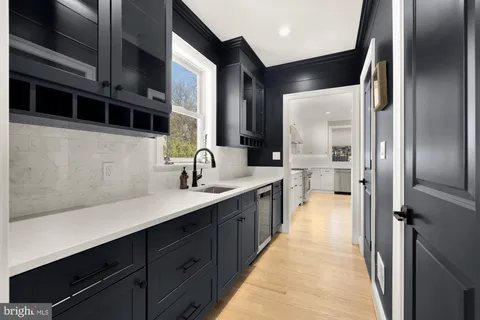 a large kitchen with a sink and stainless steel appliances