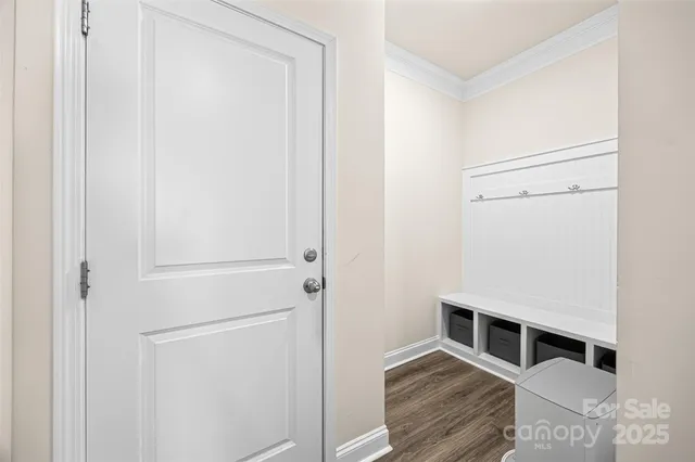 a room with wooden floor and white walls