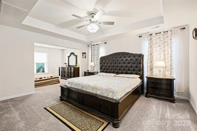 a bedroom with a bed dresser and a window