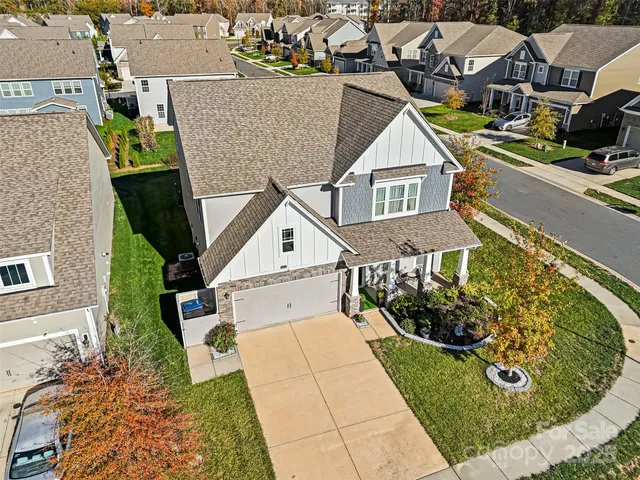 an aerial view of a house with a yard